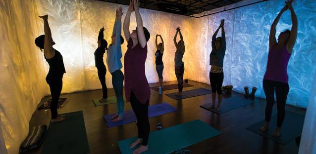 Mai-Fusco (closest to camera) joins  a yoga class surrounded by her art. Photos by Woody Myers