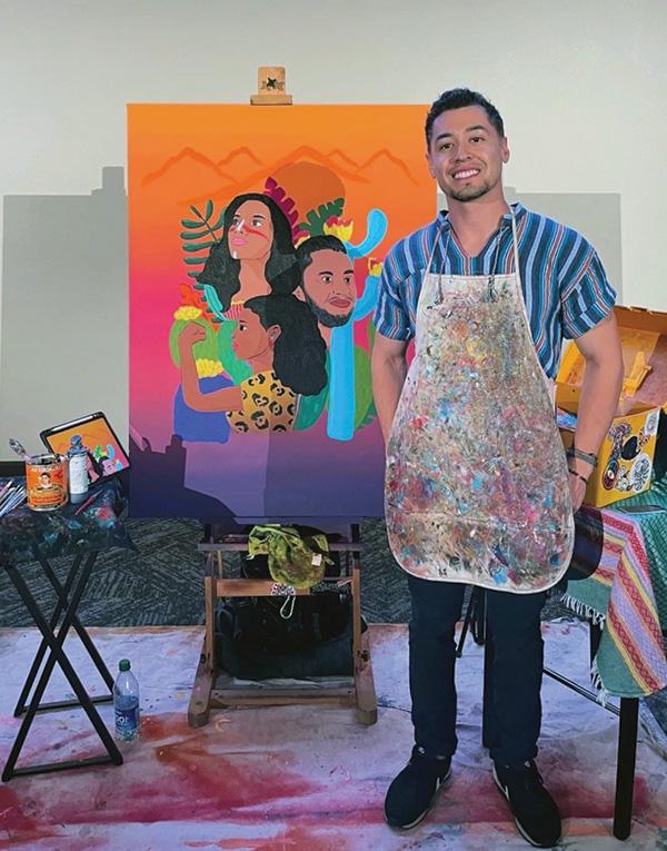 Julio Mendoza stands in front of his art.